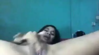Desi female lies on back and wildly masturbates her XXX cherry on camera