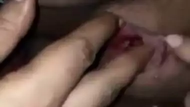 Indian woman touches her pink vagina with two hands in close-up porn