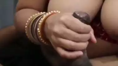 Desi Bhabhi shows boobs and gives a handjob