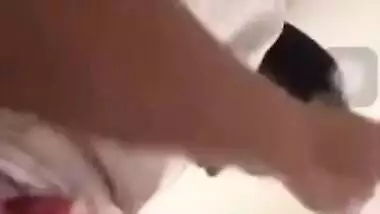 Girl performs XXX show and pulls up white T-shirt to expose boobs